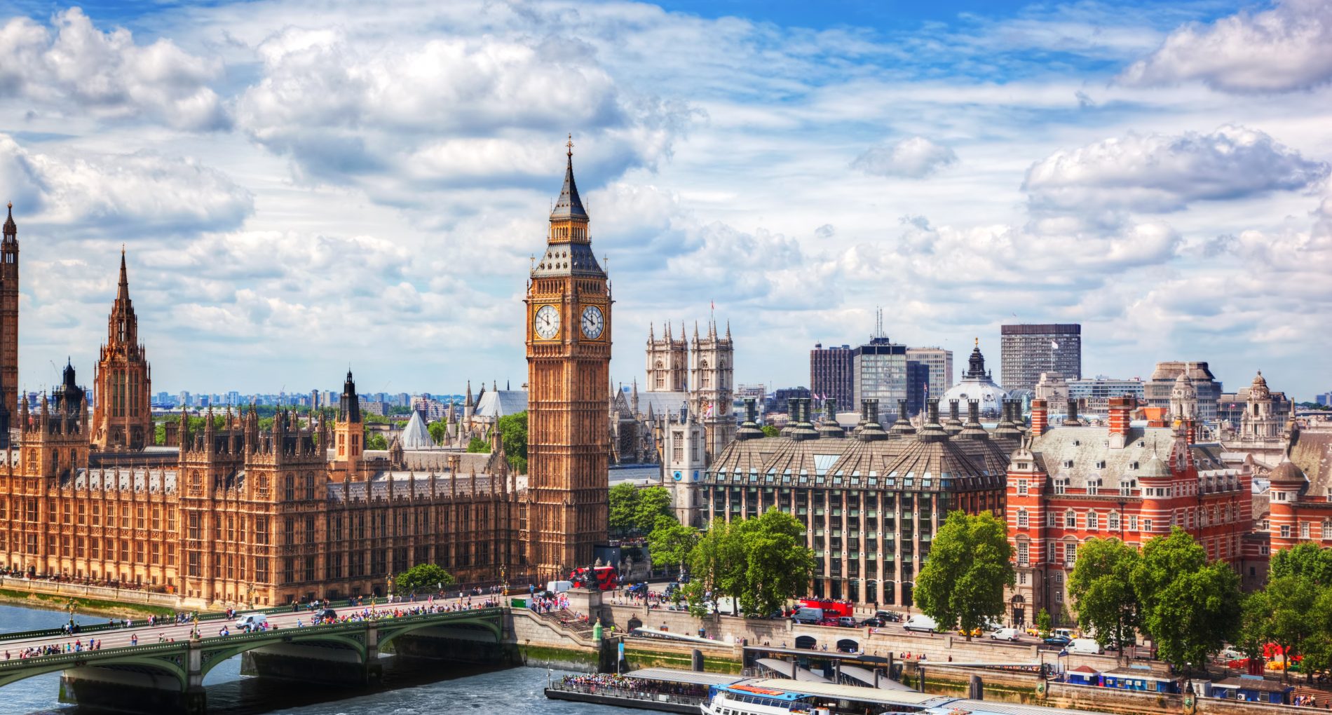 Big Ben, Westminster Bridge on River Thames in London, the UK. English symbol. Lovely puffy clouds, sunny day
